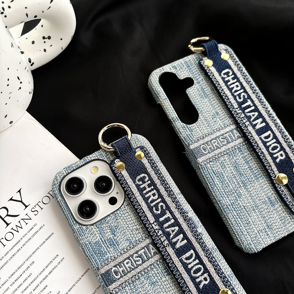Dior-inspired patterned phone case with wide hand strap