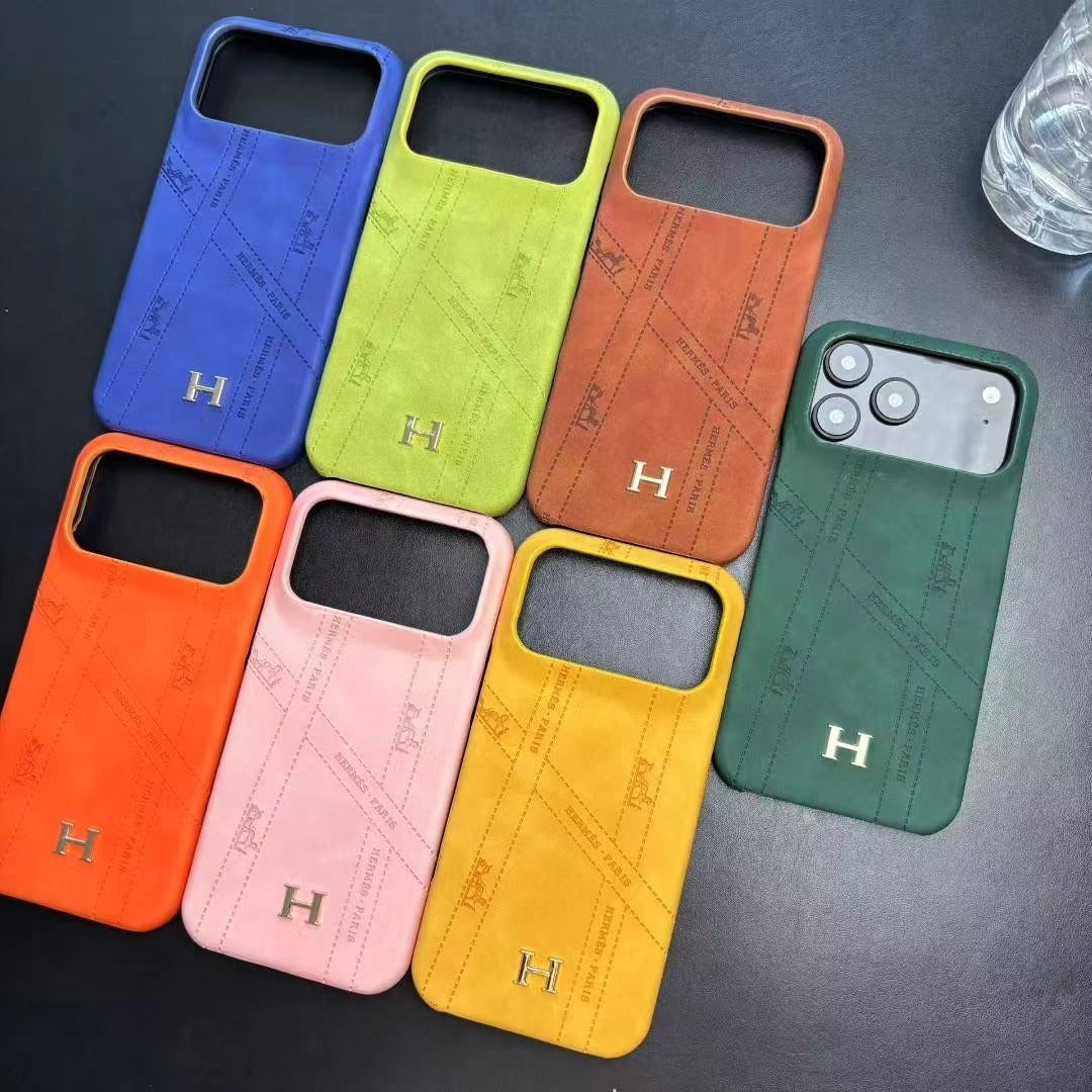 Hermes-inspired solid color iPhone 17 case with metal initial detail