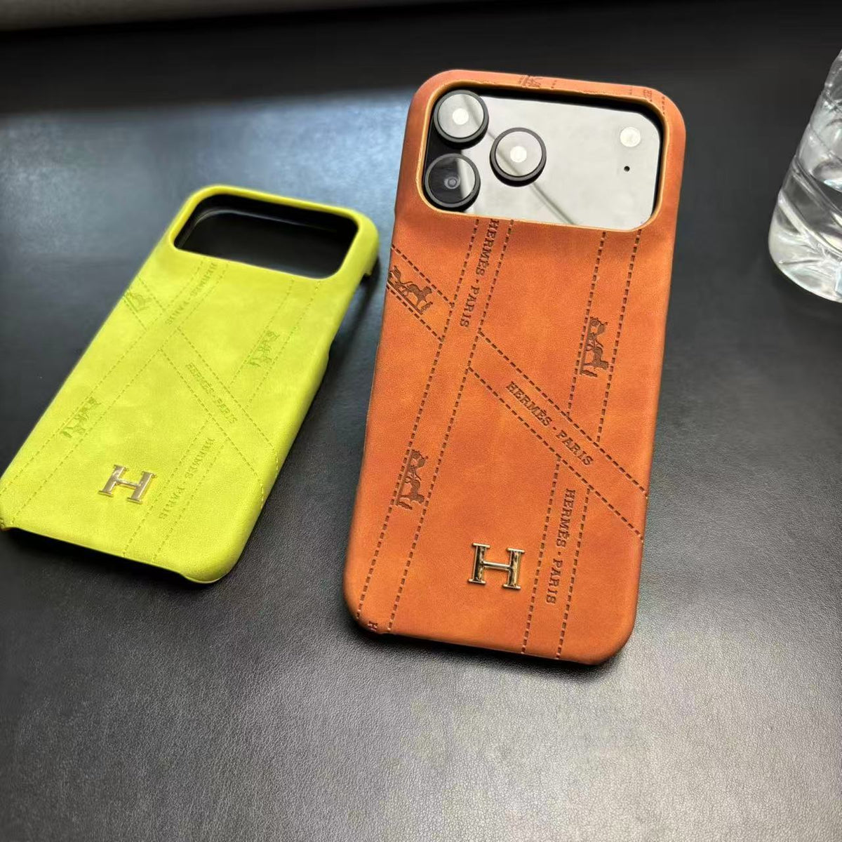 Hermes-inspired solid color iPhone 17 case with metal initial detail