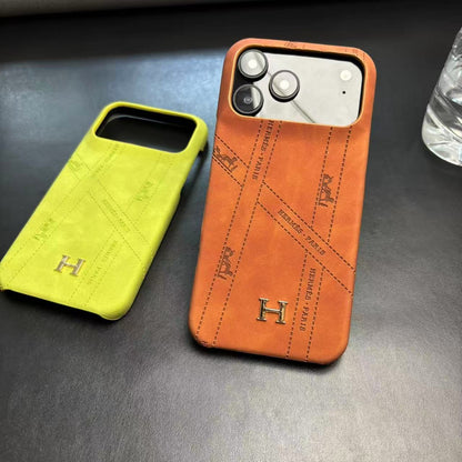 Hermes-inspired solid color iPhone 17 case with metal initial detail