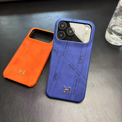 Hermes-inspired solid color iPhone 17 case with metal initial detail
