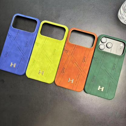 Hermes-inspired solid color iPhone 17 case with metal initial detail