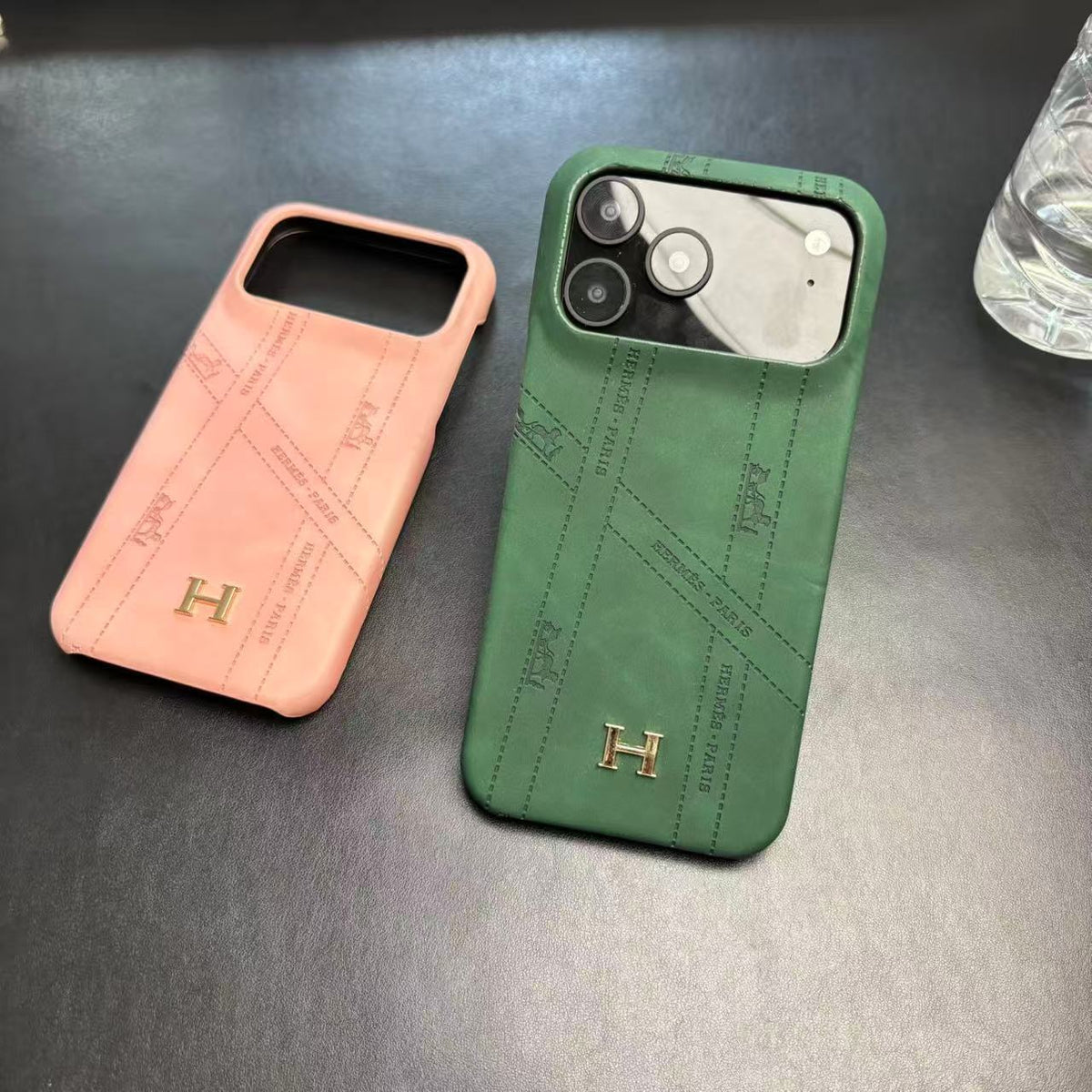 Hermes-inspired solid color iPhone 17 case with metal initial detail