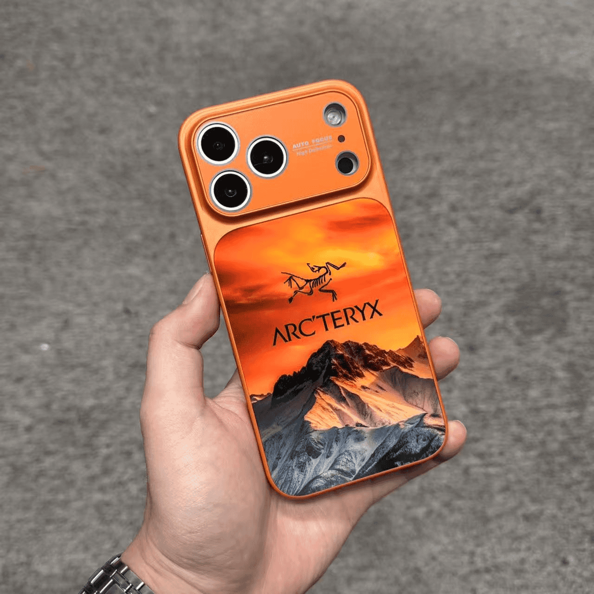 Arc'teryx-inspired mountain landscape phone case in orange