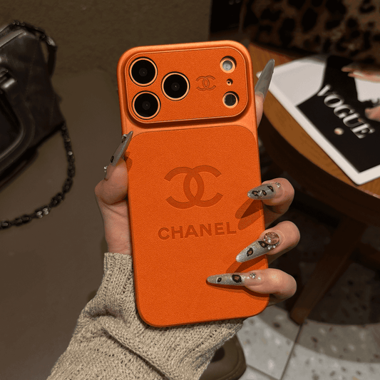 Chanel-inspired solid color iPhone case with embossed emblem, orange