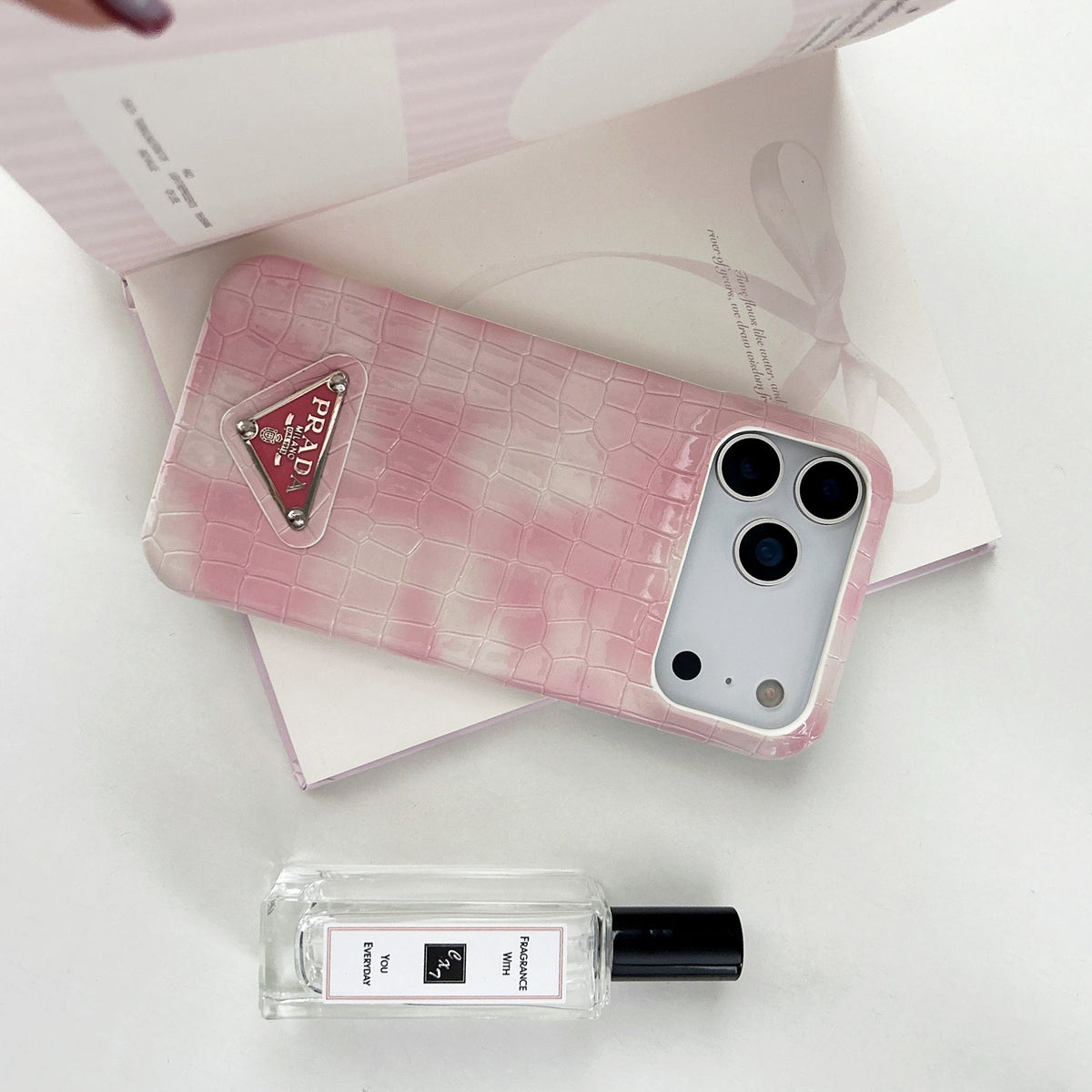 Prada-inspired pastel textured iPhone 17 case with triangle detail