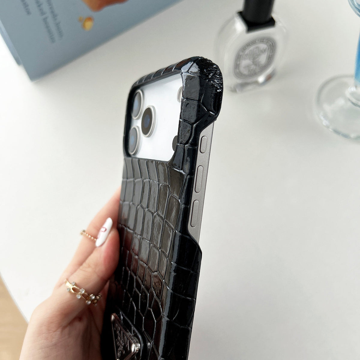 Prada-inspired pastel textured iPhone 17 case with triangle detail